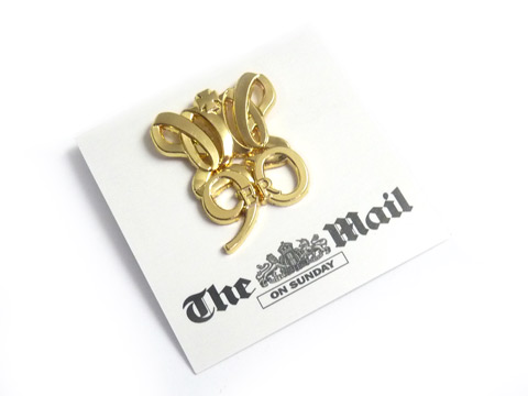 Custom Gold plated Queens lapel badges on branded printed backing card
