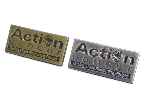 Action Cancer charity badges.